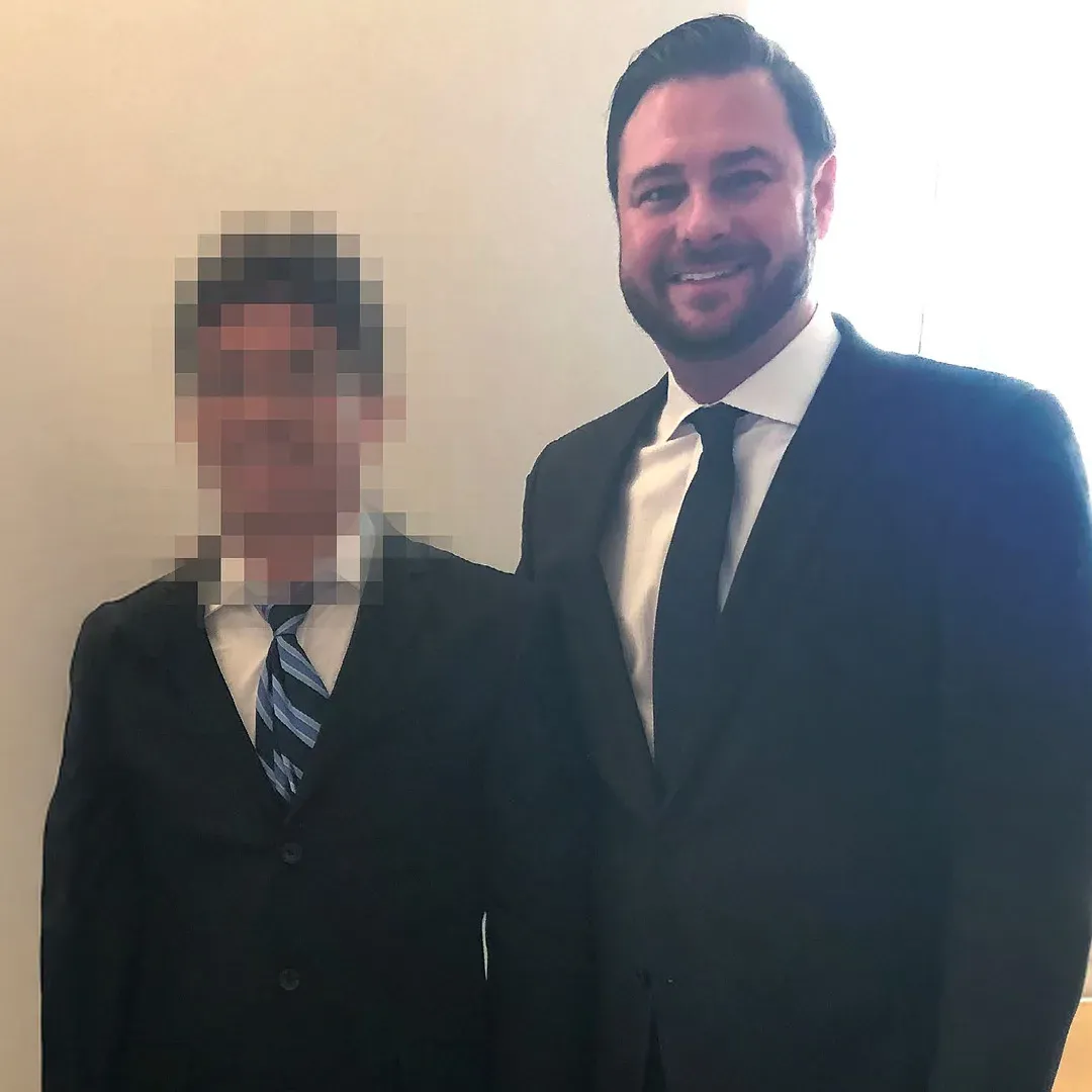 Adam Rossen with a client, the client’s face blurred for privacy
