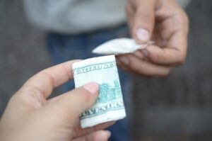 Mano de una mujer comprando cocaína