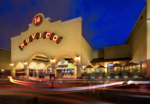 A photograph of the Muvico movie theater in Boynton Beach, Florida, at night with its exterior lights illuminated.