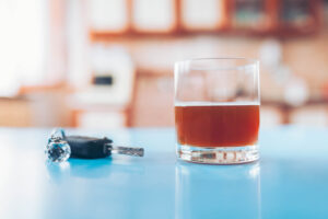 DUI Defense Attorney_Fort Lauderdale_ Boca Raton_Drink driving. Car key and a glass of liquor on table
