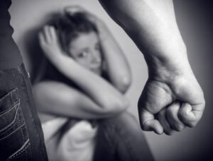 Woman victim of domestic violence and abuse. Husband intimidates his wife. Focus on hand