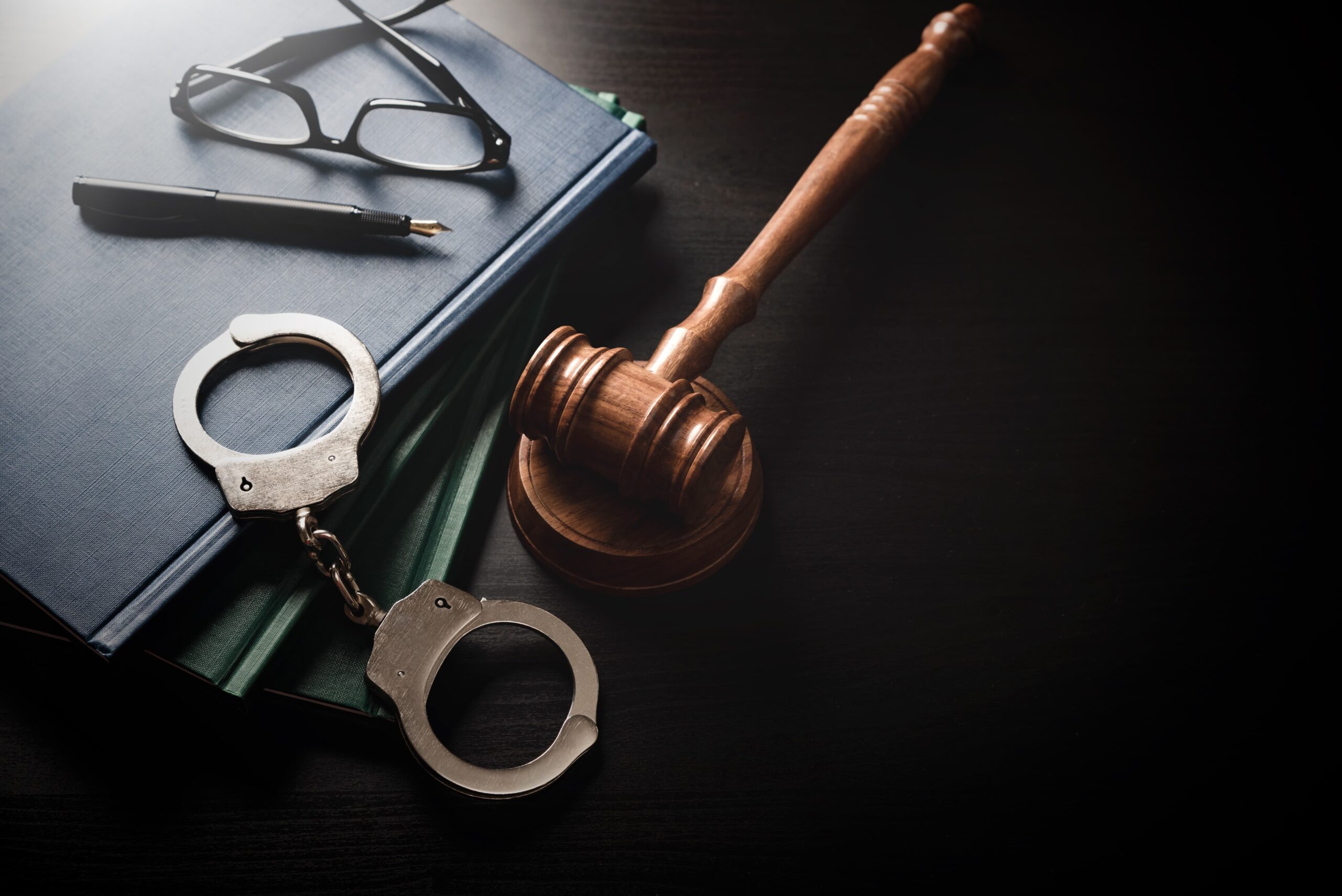handcuffs and gavel on table